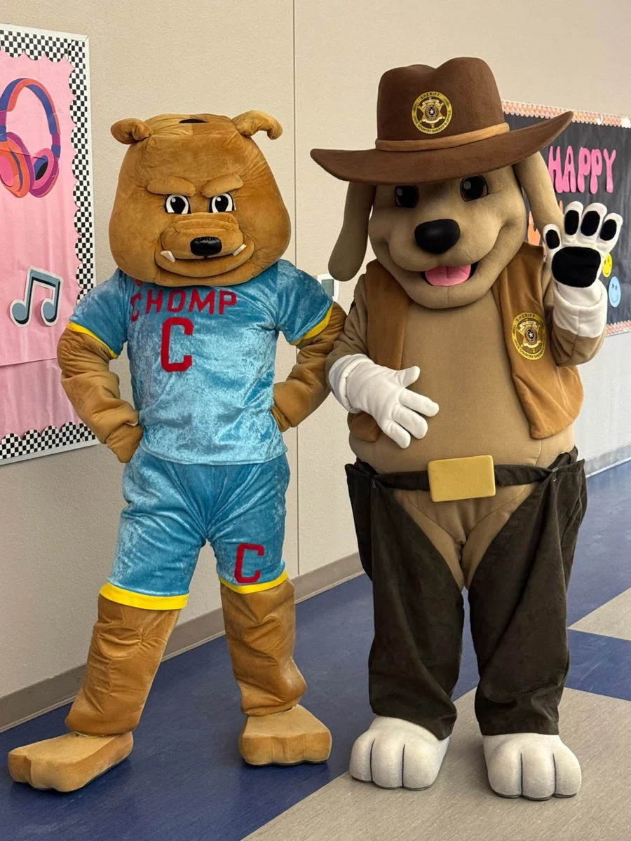 CHOMP mascot posing with a sheriff dog mascot at Bryson Elementary