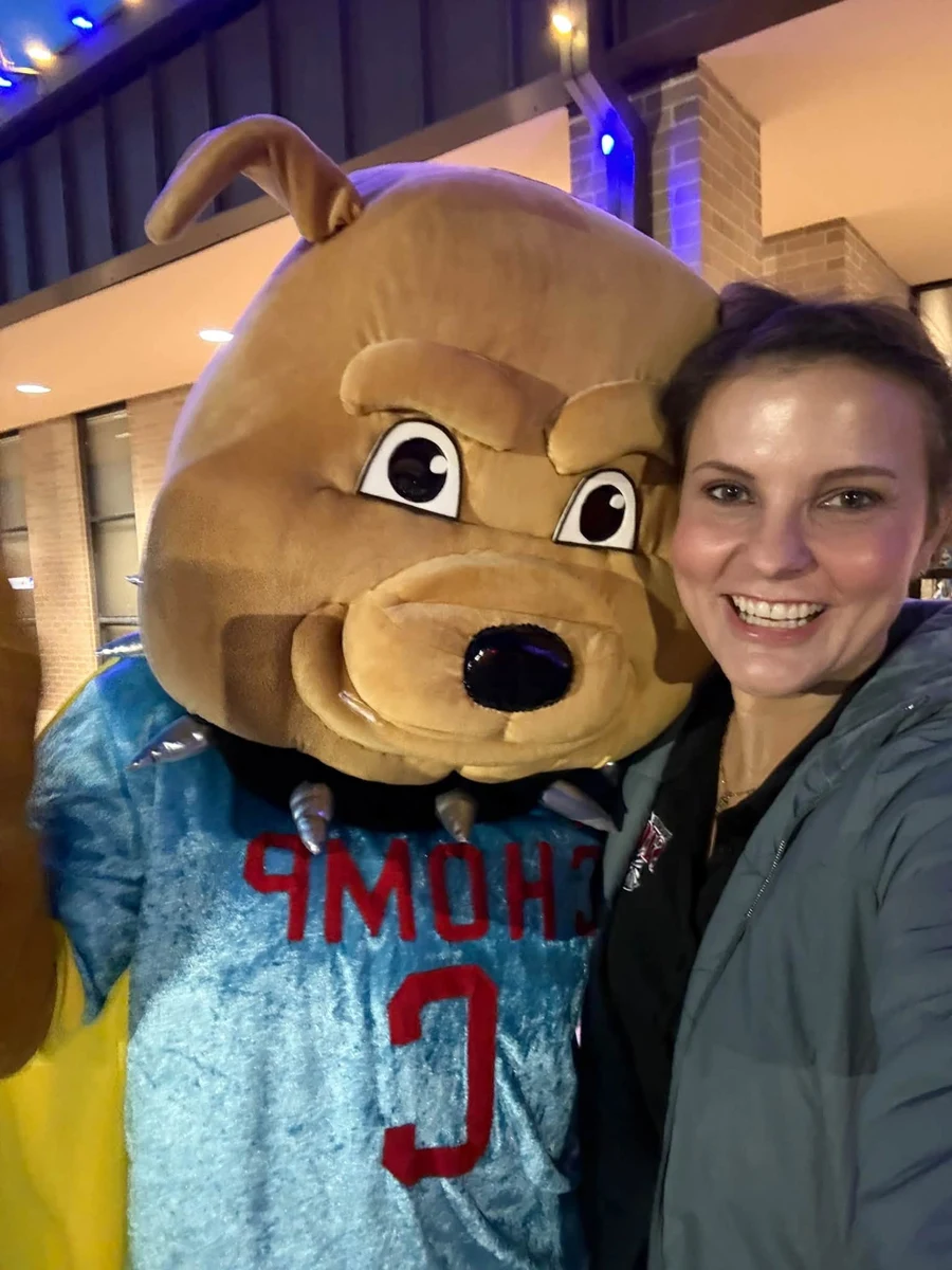 A guest taking a photo with the CHOMP mascot