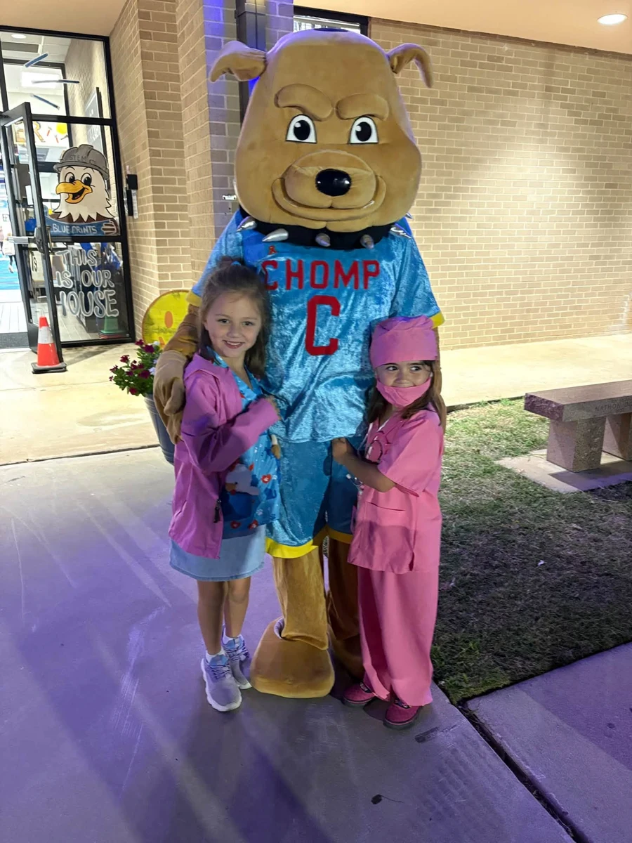 CHOMP mascot with students during a school visit at Enis Elementary