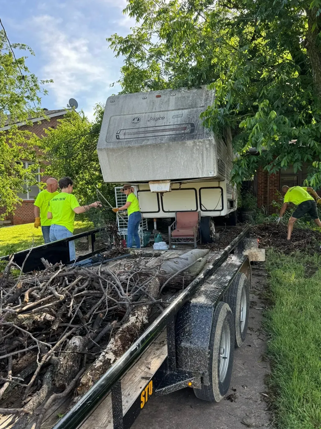 Volunteers clearing debris into a trailer