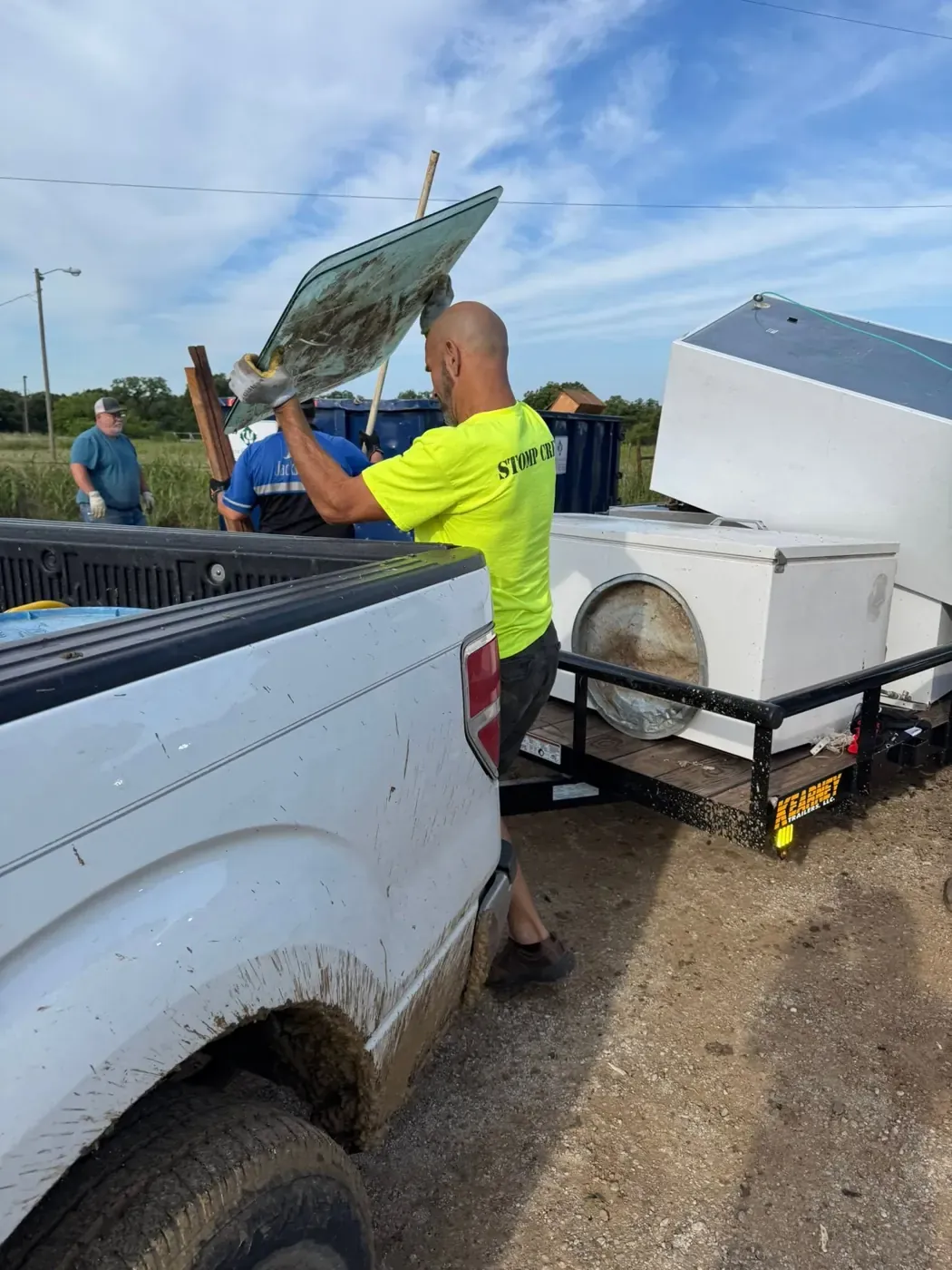A STOMP crew member hauling debris