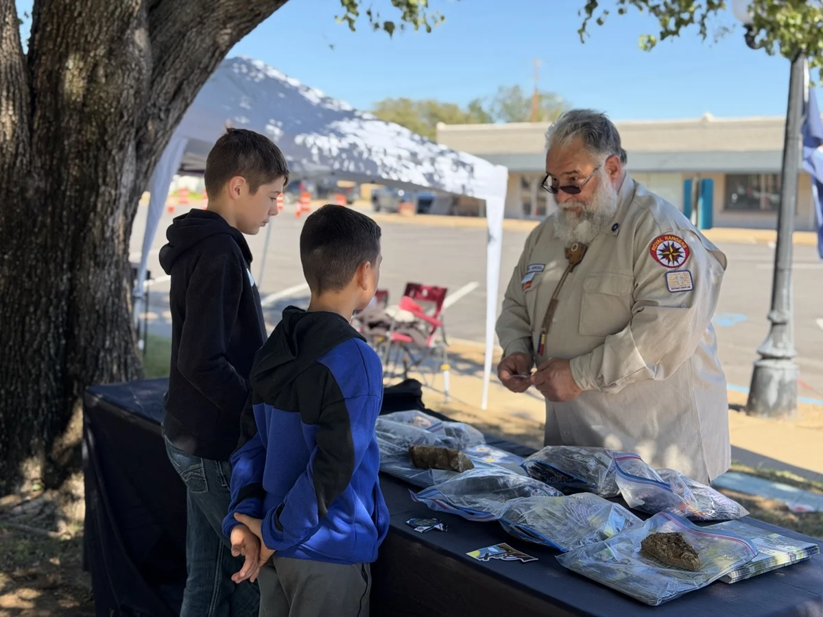 Royal Rangers leader talking with two visitors