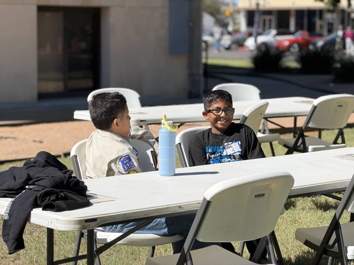 Young derby participants relaxing at festival tables