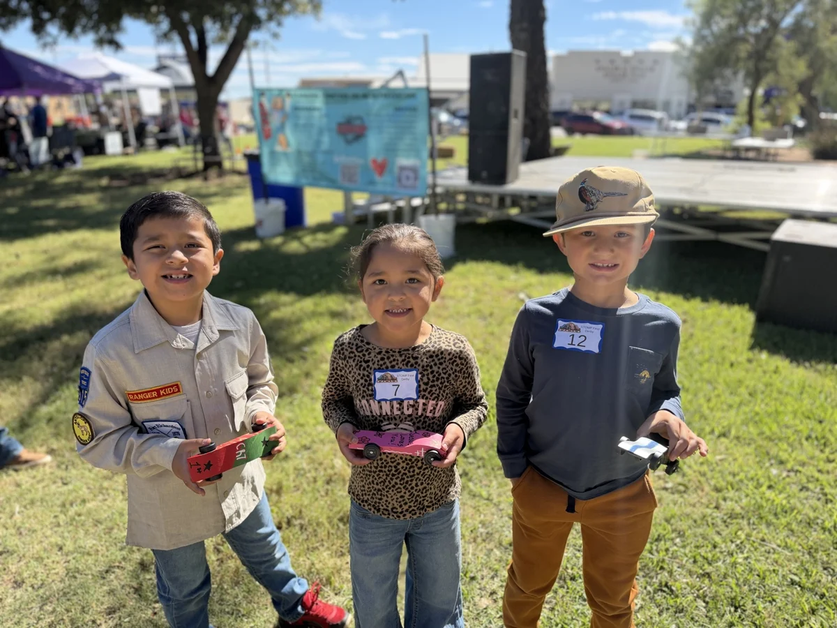 Children holding their decorated derby cars