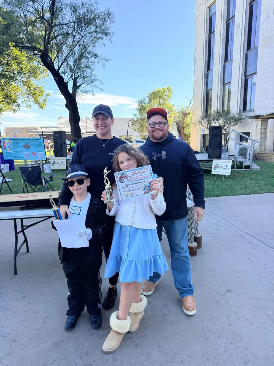 Festival participants posing together with awards at STOMP Fest 2026